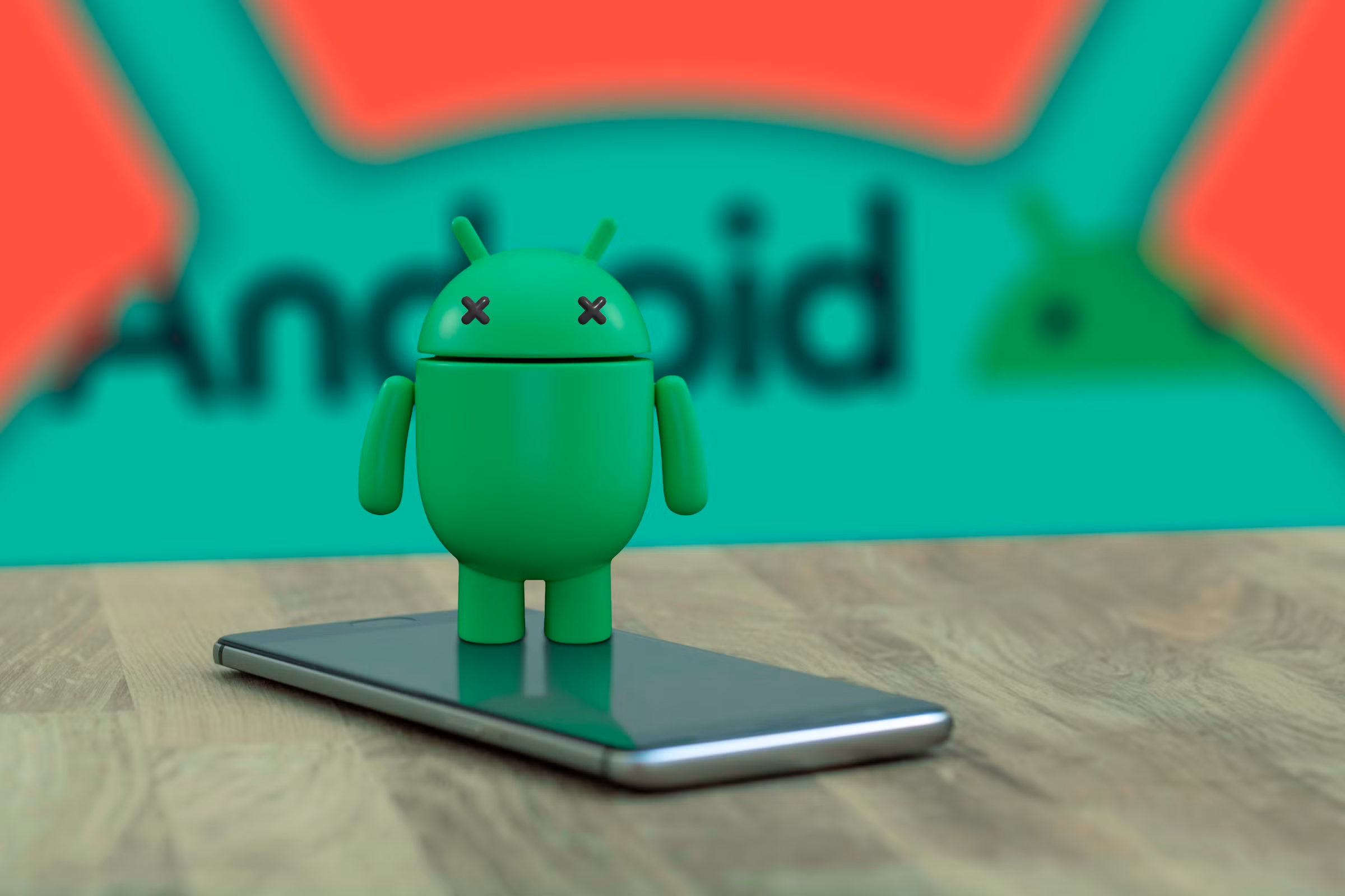 android-mascot-on-top-of-a-phone-with-x-eyes-indicating-that-it-is-dead-and-the-android-logo-in-the-background
